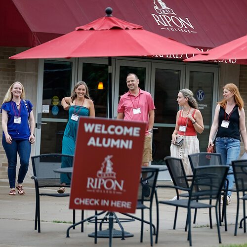 A group of alumni visit while exiting the Commons at Alumni Weekend